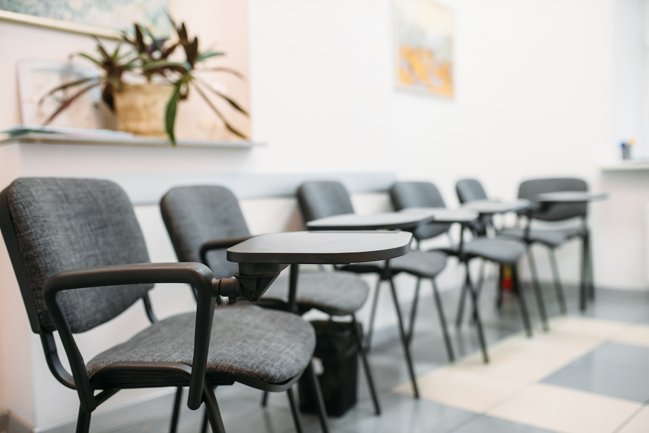 conference room full of chairs with plastic armrests