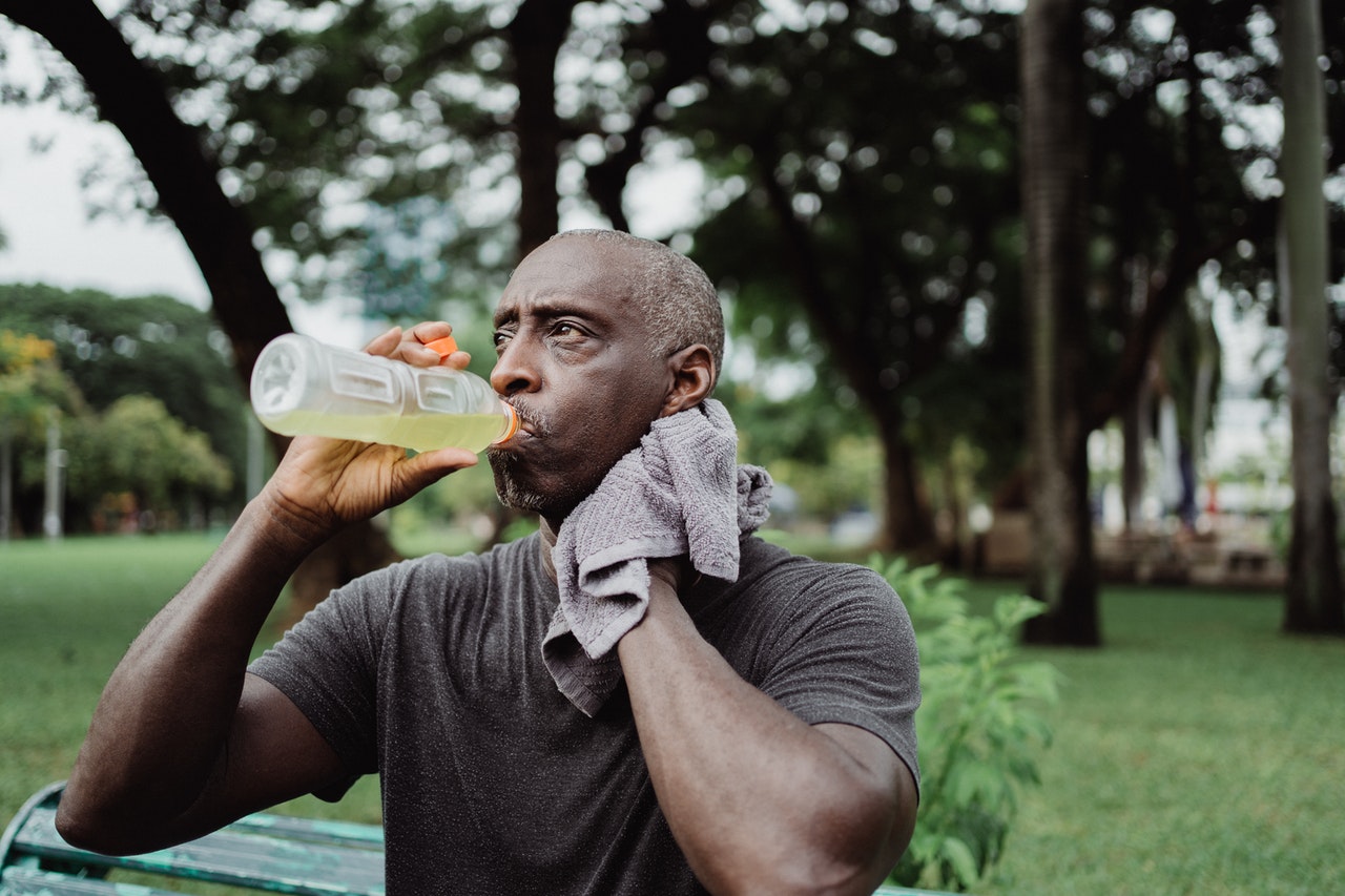 A man drinking from a plastic sports drink bottle