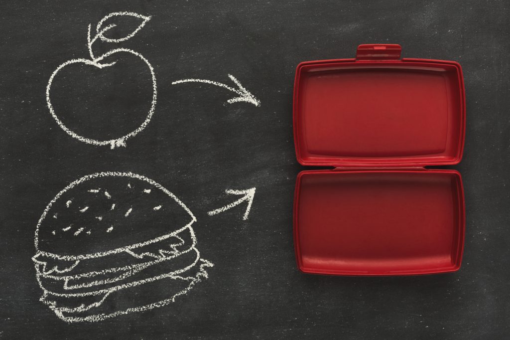 Empty plastic food container on black background