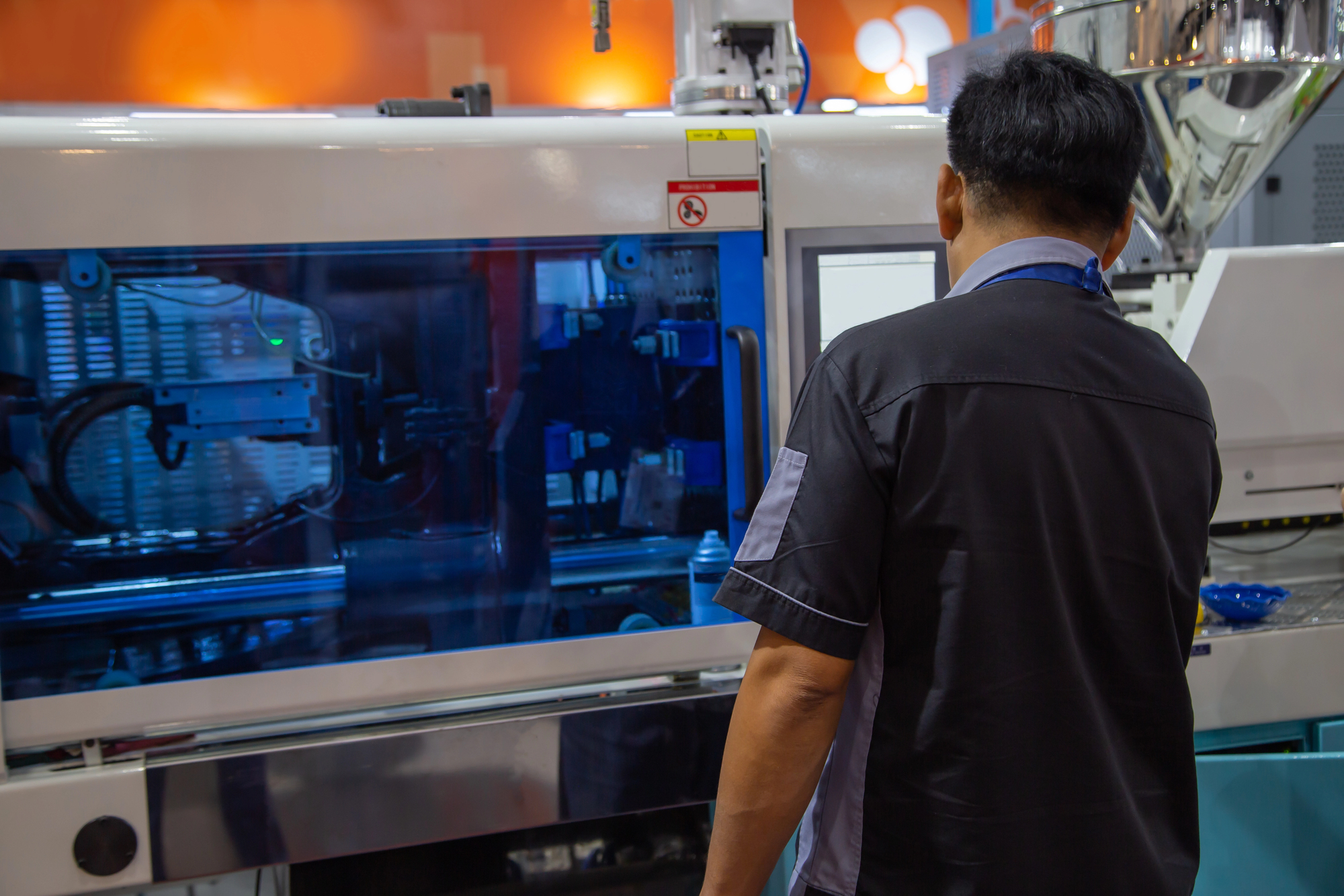 A plastic mold maker in the process of precision plastic injection molding