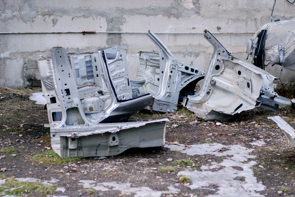 Large automotive body components showing warping and structural defects in molded parts